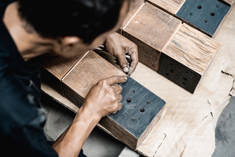 A skilled artisan meticulously works on wooden blocks, showcasing expertise in carpentry and craftsmanship.
