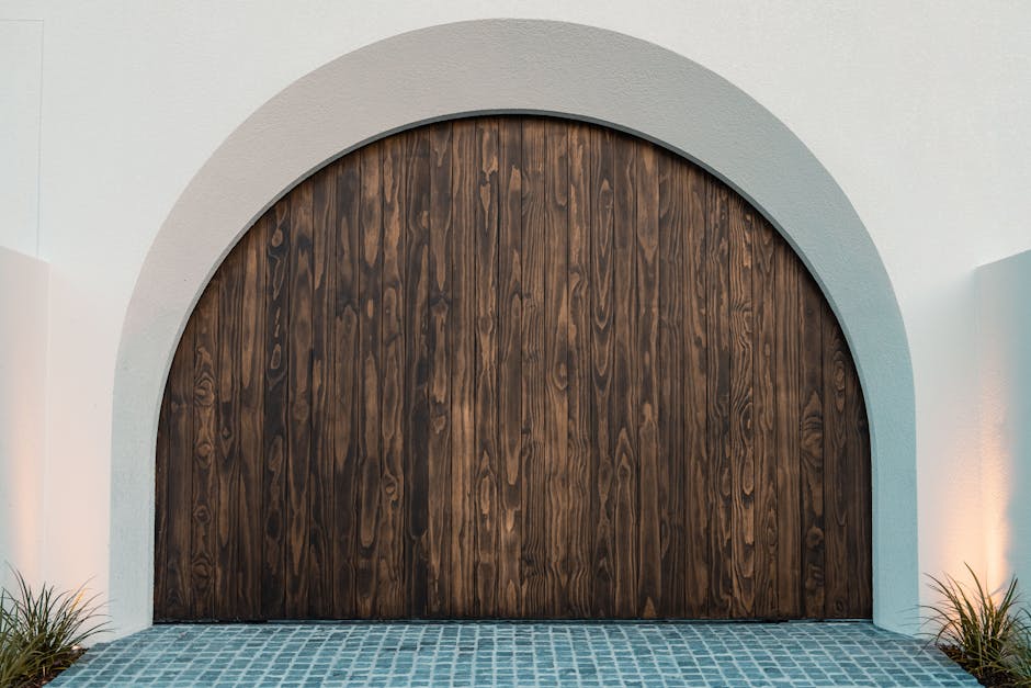 A striking wooden arched entrance at a modern Gold Coast residence, showcasing elegant design.